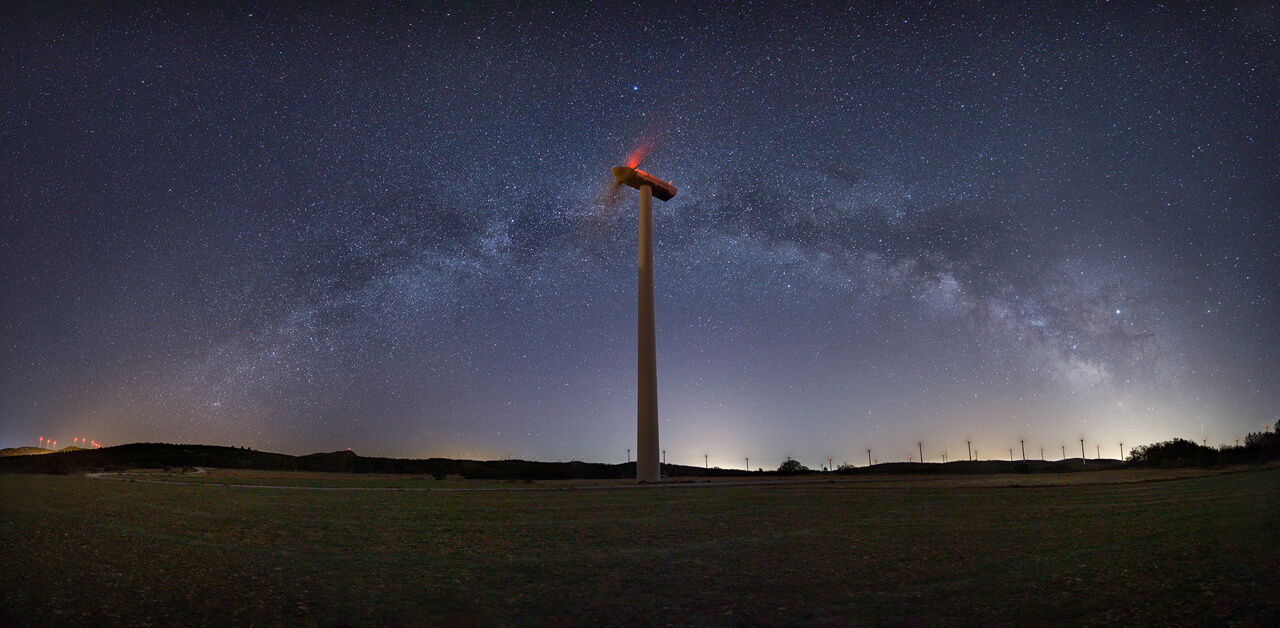 Panoramic Milky Way over turbine